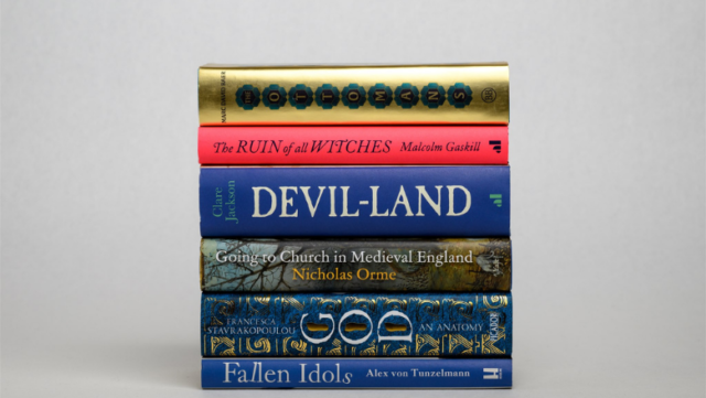 The six hardback books shortlisted for the Wolfson History Prize 2022 stacked on top of each other. From top to bottom: The Ottomans: Khans, Caesars and Caliphs by Marc David Baer; The Ruin of All Witches: Life and Death in the New World by Malcolm Gaskill; Devil-Land: England Under Siege, 1588-1688 by Clare Jackson; Going to Church in Medieval England by Nicholas Orme; God: An Anatomy by Francesca Stavrakopoulou; Fallen Idols: Twelve Statues That Made History by Alex von Tunzelmann